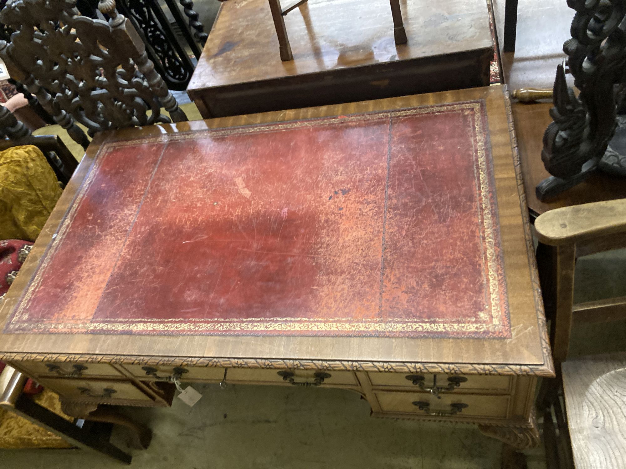 A Queen Anne revival mahogany kneehole desk, length 122cm, depth 76cm, height 76cm